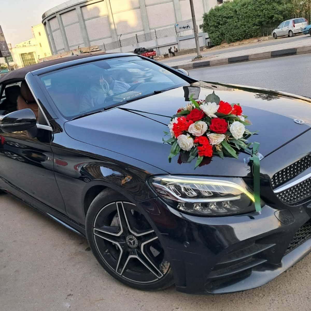 عروسان داخل سيارة زفاف مزينة